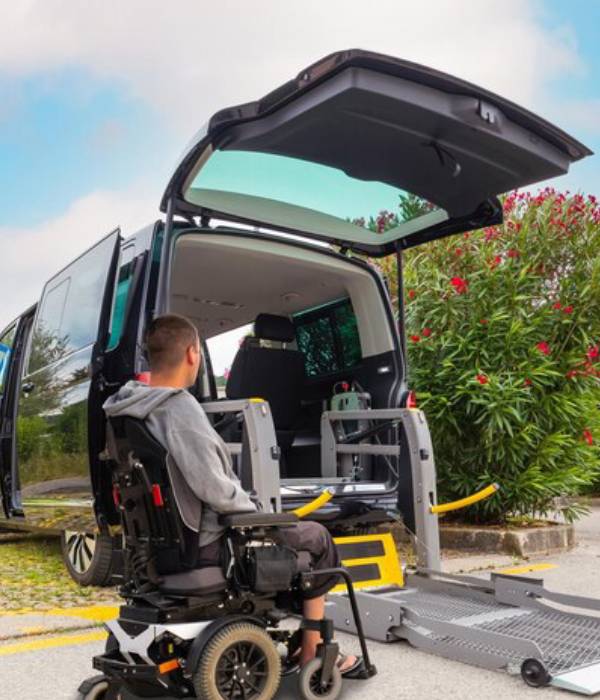 Wheelchair passenger loading into an accessible taxi van
