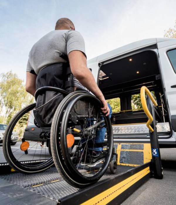 Mobility aid user boarding a wheelchair friendly taxi